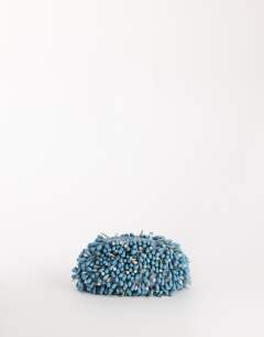 Model wearing Jemma beaded clutch bag in blue