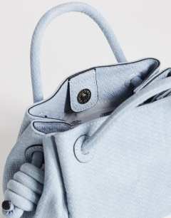 Model wearing Jenny grab weave bag in blue suedette