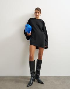 Model wearing Jersey cotton high v neck long sleeve mini dress in black