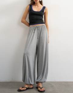 Model wearing Jersey viscose balloon trousers in grey marl