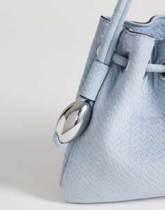 Model wearing Jessie medium hardware grab in blue weave
