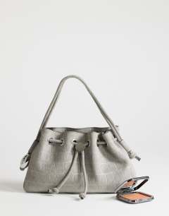 Model wearing Jessie medium hardware grab in grey croc