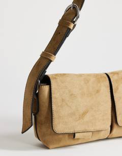 Model wearing Joanie small suedette shoulder bag with front pockets in taupe