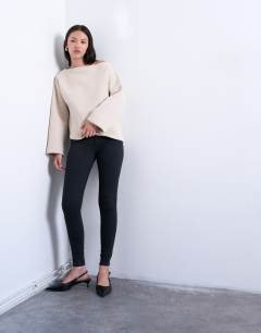 Model wearing Joni skinny high rise jean in washed black