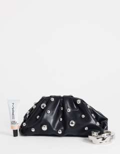 Model wearing Josephine small studded clutch bag in black