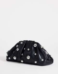 Model wearing Josephine small studded clutch bag in black