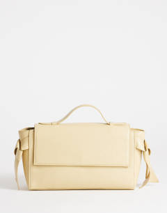 Model wearing Josie small grab knot detail grab bag in buttermilk