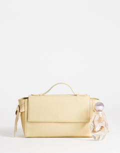 Model wearing Josie small grab knot detail grab bag in buttermilk