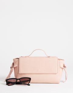 Model wearing Josie small grab knot detail grab bag in pink