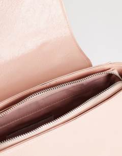 Model wearing Josie small grab knot detail grab bag in pink