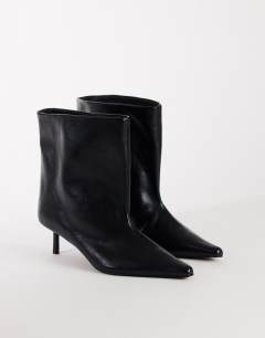Model wearing Kai super wide heeled ankle boot in black