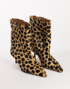 Model wearing Kai super wide heeled ankle boot in leopard pony hair on real leather