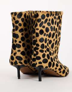 Model wearing Kai super wide heeled ankle boot in leopard pony hair on real leather