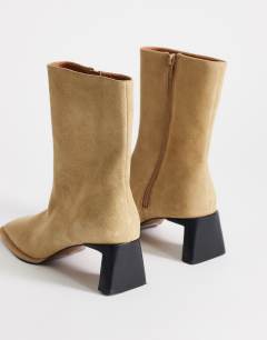 Model wearing Kali real suede heeled ankle boot in sand
