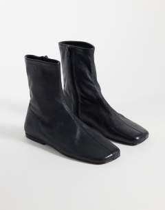 Model wearing Kameron real leather flat ankle boot in black