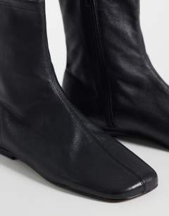 Model wearing Kameron real leather flat ankle boot in black