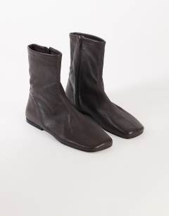 Model wearing Kameron real leather flat ankle boot in chocolate