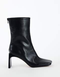 Model wearing Kane angular heeled ankle boot in black