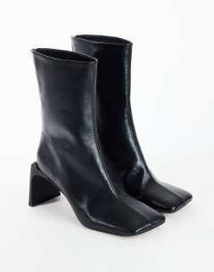 Model wearing Kane angular heeled ankle boot in black
