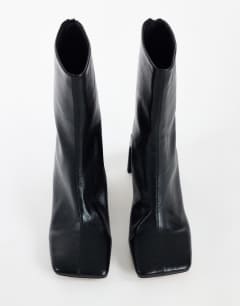 Model wearing Kane angular heeled ankle boot in black