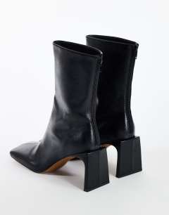 Model wearing Kane angular heeled ankle boot in black