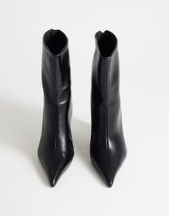 Model wearing Kendrick sculpted wedge ankle boot in black
