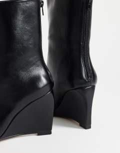 Model wearing Kendrick sculpted wedge ankle boot in black