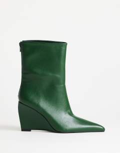 Model wearing Kendrick sculpted wedge ankle boot in dark green