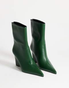 Model wearing Kendrick sculpted wedge ankle boot in dark green