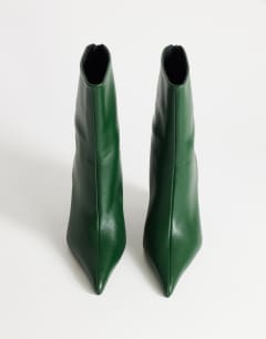 Model wearing Kendrick sculpted wedge ankle boot in dark green