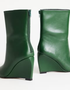 Model wearing Kendrick sculpted wedge ankle boot in dark green