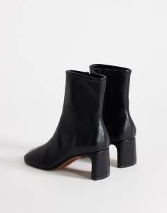 Model wearing Kenna block heel ankle boot in black
