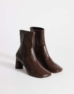 Model wearing Kenna block heel ankle boot in chocolate