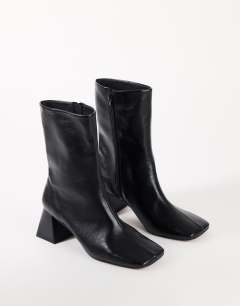 Model wearing Kenton block heel ankle boot in black