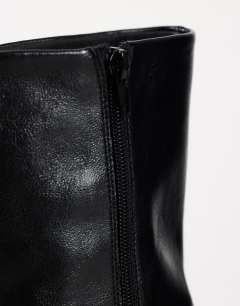 Model wearing Kenton block heel ankle boot in black