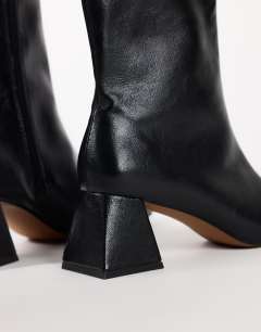Model wearing Kenton block heel ankle boot in black