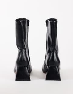 Model wearing Kenton block heel ankle boot in black