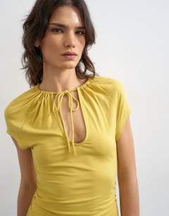 Model wearing Keyhole detail top in ochre