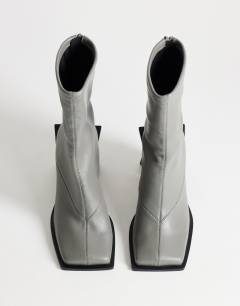 Model wearing Kiara extended rand heeled ankle boot in grey