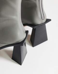 Model wearing Kiara extended rand heeled ankle boot in grey