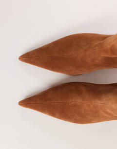 Model wearing Kiki cone heel ankle boot in chestnut suede