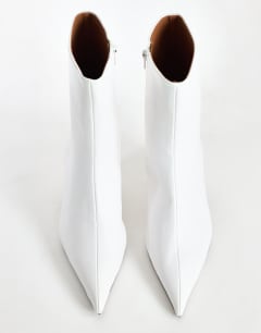 Model wearing Kiki cone heel ankle boot in off white