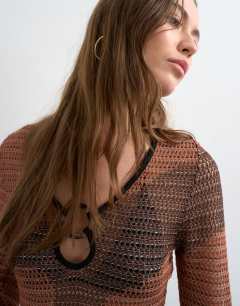 Model wearing Knitted abstract mesh long sleeve maxi dress in burnt orange