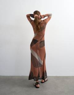 Model wearing Knitted abstract mesh long sleeve maxi dress in burnt orange