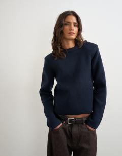 Model wearing Knitted all needle shoulder padded jumper in navy