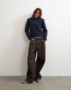 Model wearing Knitted all needle shoulder padded jumper in navy