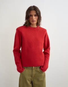 Model wearing Knitted all needle shoulder padded jumper in red
