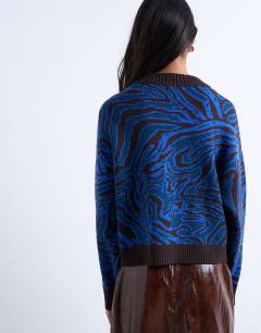 Model wearing Knitted animal print cardigan in blue