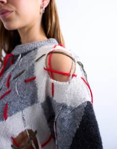 Model wearing Knitted argyle distressed jumper