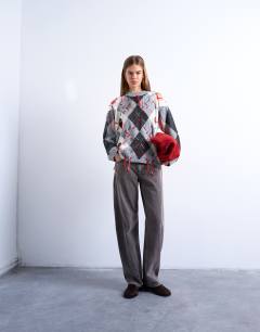 Model wearing Knitted argyle distressed jumper